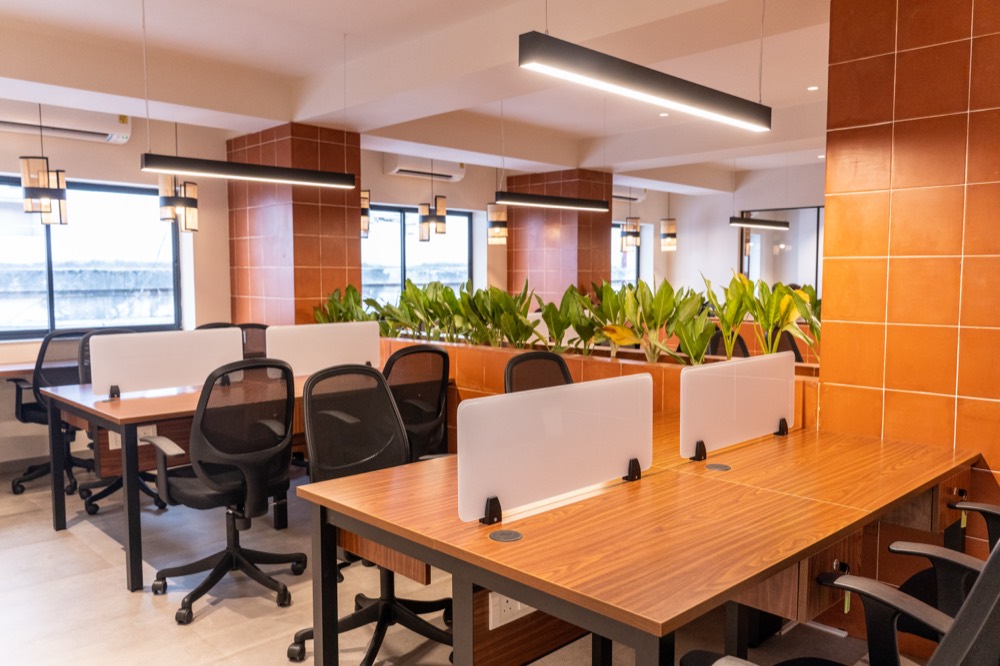 The open workspace with wooden desks and terracotta pillars